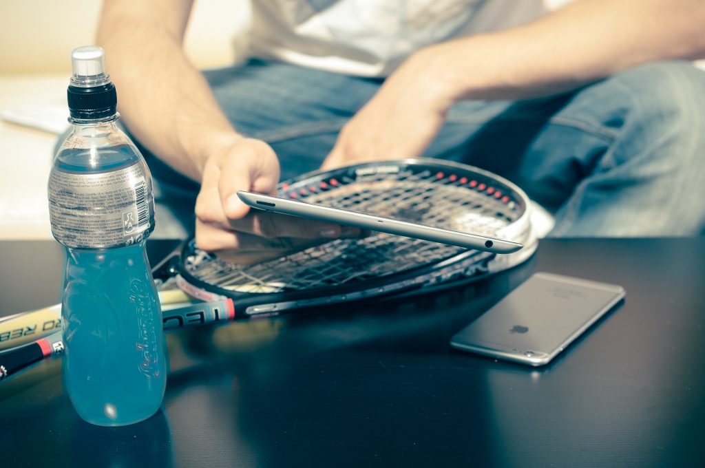 A person holding a bottle of water on a table