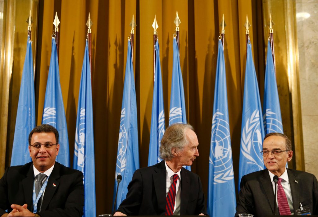 Hadi al-Bahra et al. standing in front of a curtain