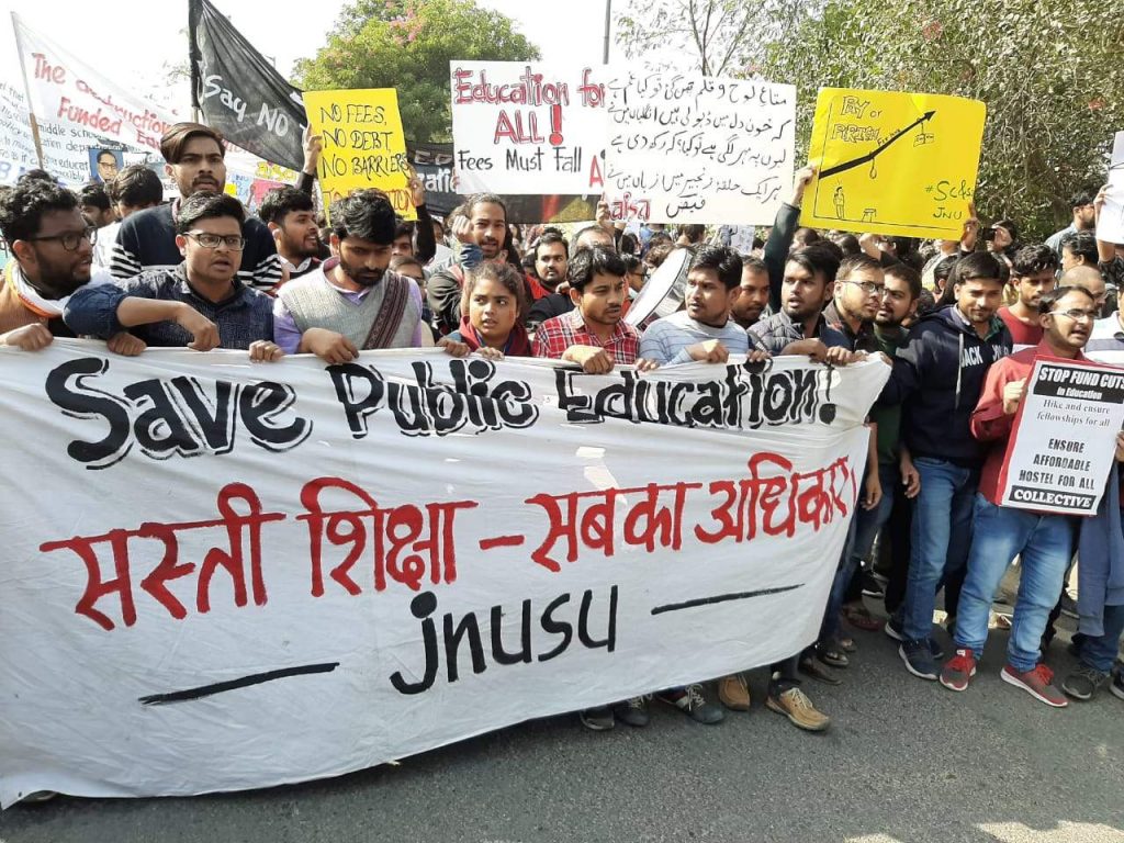 A group of people holding a sign