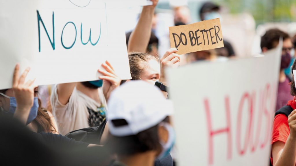 A group of people holding a sign