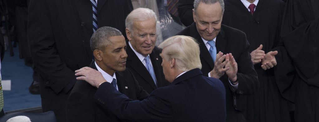 Barack Obama, Joe Biden, Chuck Schumer standing next to a person in a suit and tie