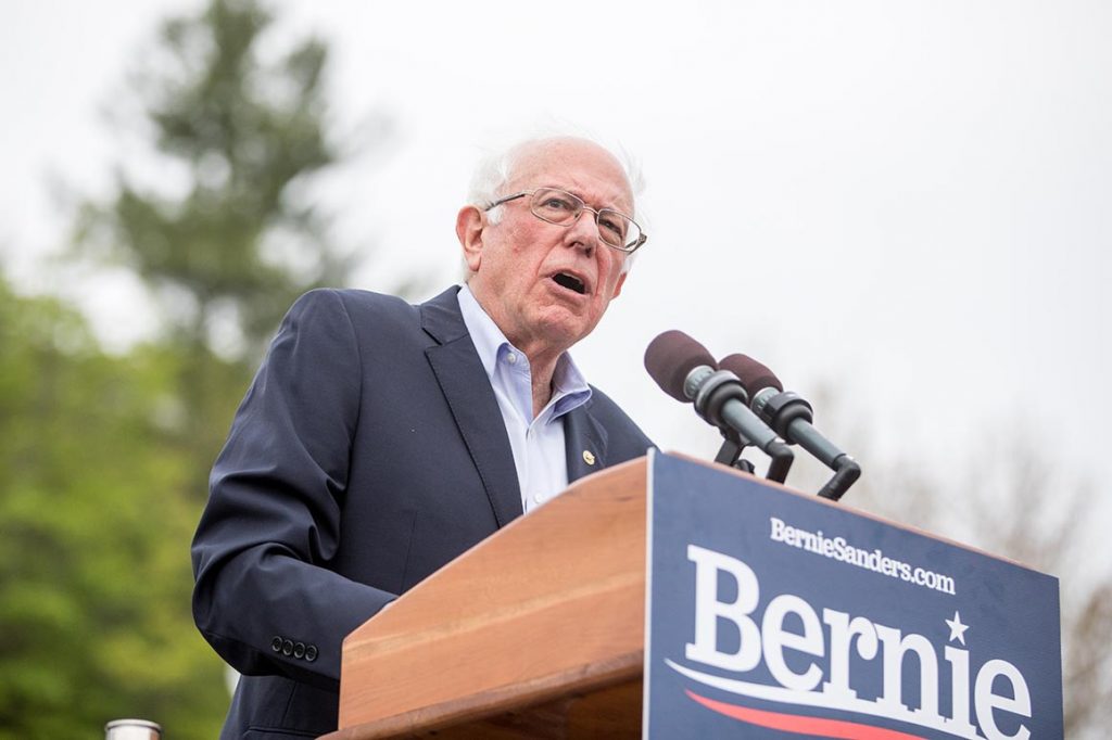 Bernie Sanders holding a sign