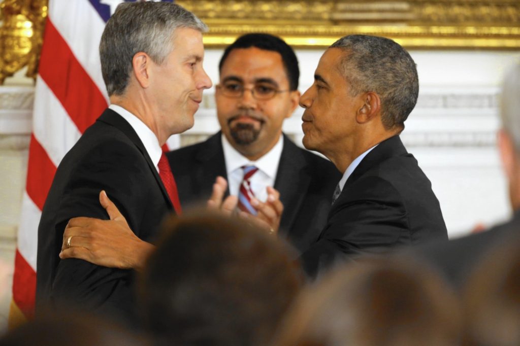 John King et al. looking at a man in a suit and tie