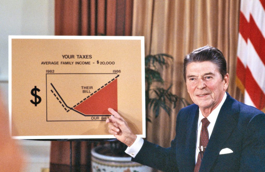 Ronald Reagan holding a sign