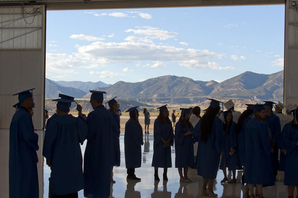 A group of people standing in front of a mountain
